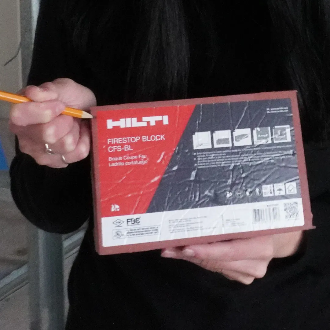 Fire-stopping inspections for NYC apartment renovations Architect holding a Hilti CFS-BL firestop block on a New York City apartment renovation site