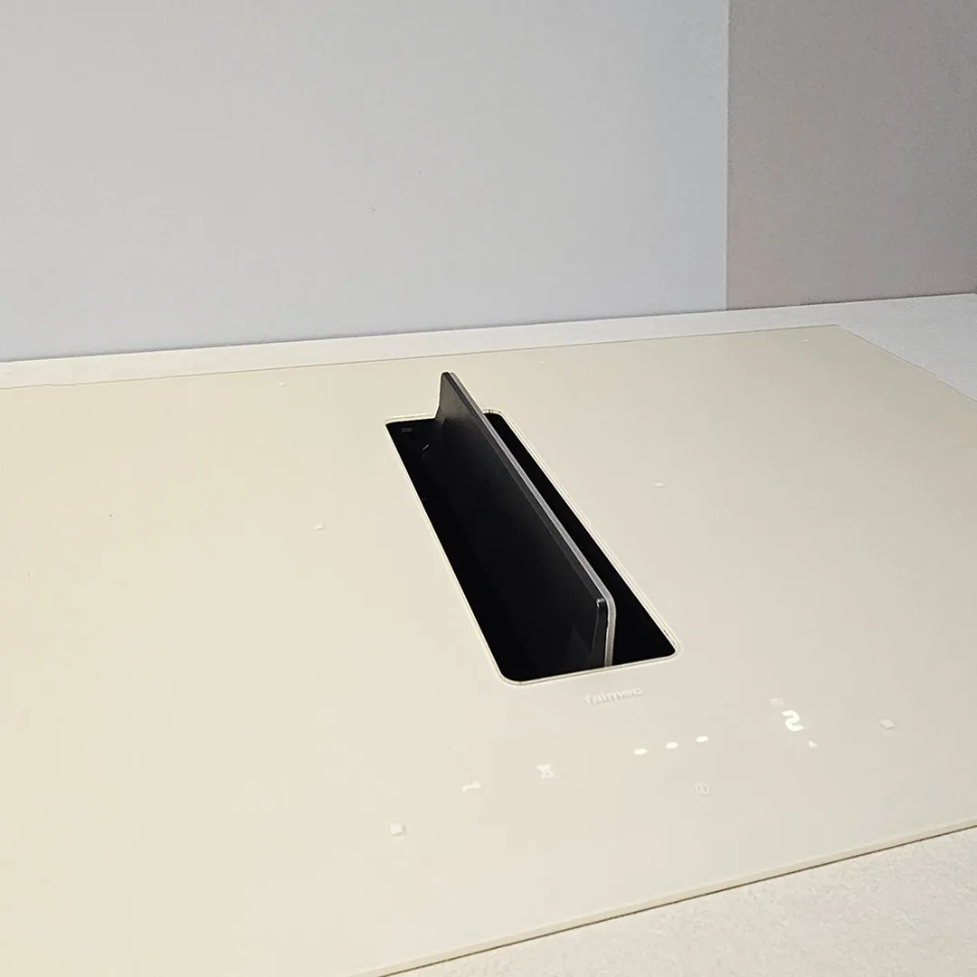 9 kitchen design trends for 2027, an Architect’s view Kitchen design trend for 2027: a cream Falmec induction cooktop set flush in the countertop, with its integrated downdraft extraction flap raised