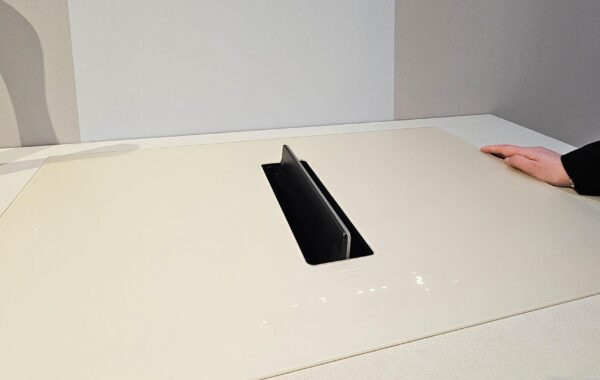 Kitchen design trend for 2027: a cream Falmec induction cooktop set flush in the countertop, with its integrated downdraft extraction flap raised