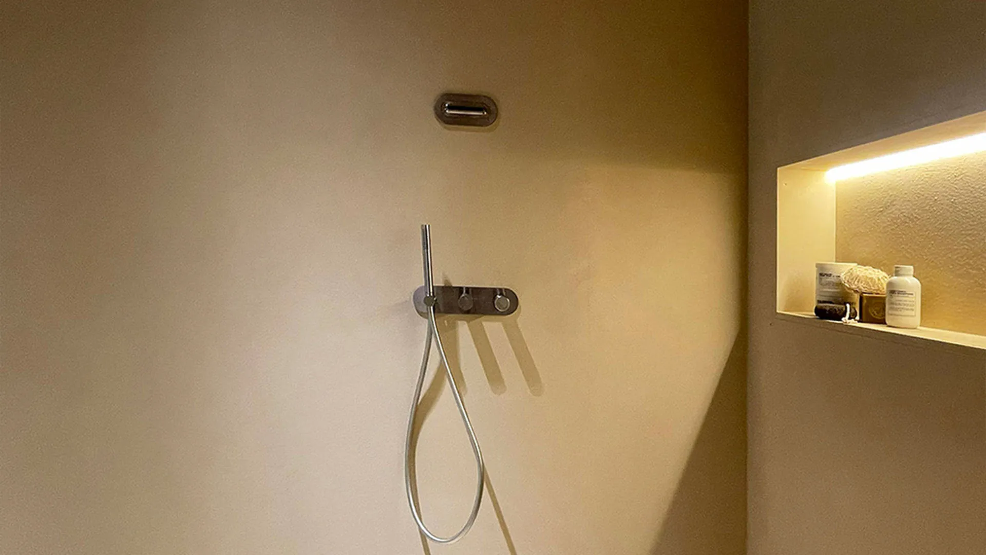 Recessed shower niche with hand shower in a renovated NYC bathroom