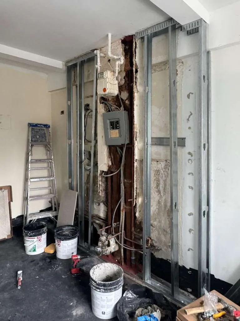 Steel wall framing and construction materials during a prewar apartment renovation at 330 West 72nd Street.
