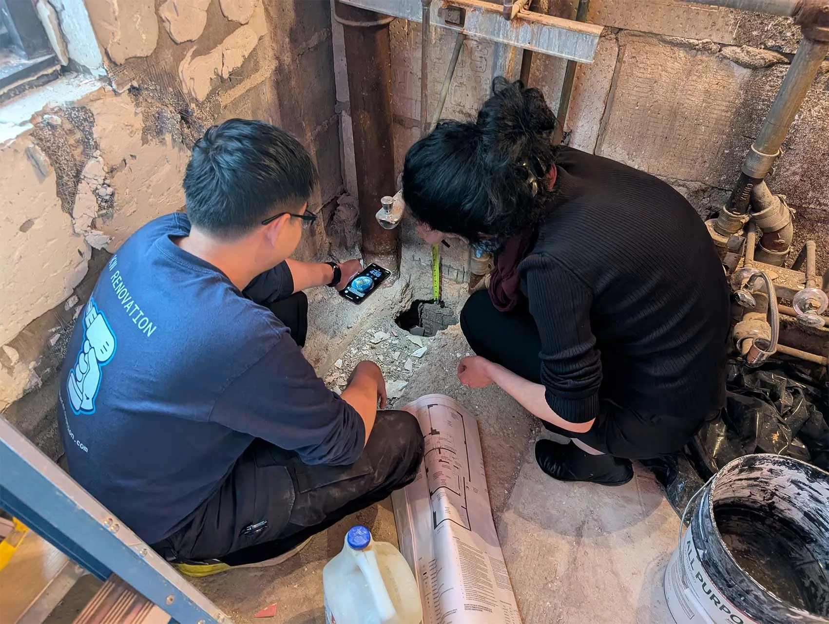 Special Inspection Agency team checking plumbing penetrations at the floor slab during a two-bedroom gut renovation in Manhattan