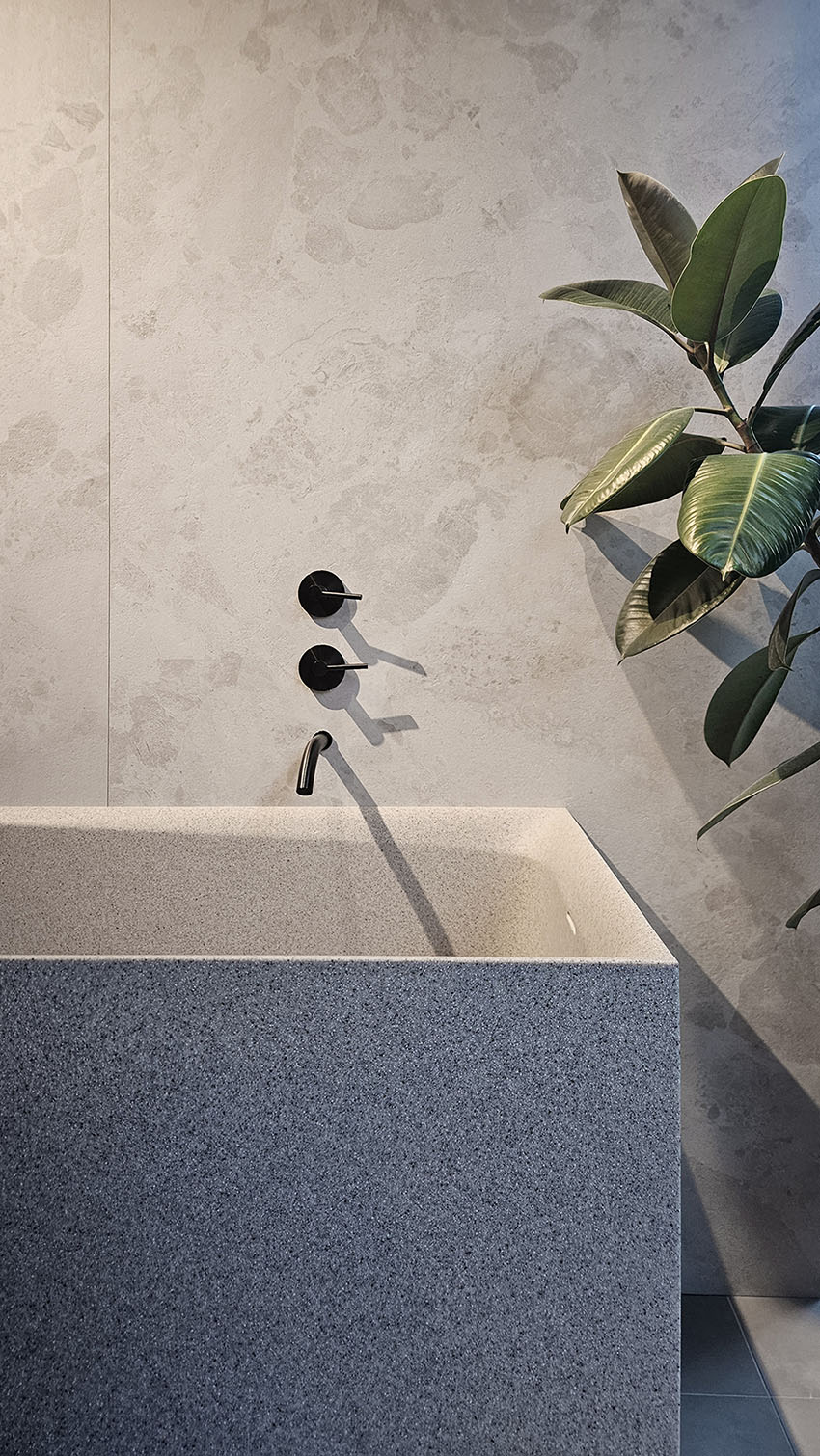Concrete-finish bathroom with soaking tub